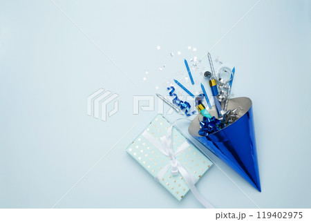 Birthday attributes colorful balloons, party hats, candles, and confetti. Concept of festive birthday celebrations 119402975