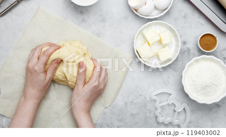 Making different shapes of fall cookies for Halloween. Woman rolling out dough Making different shapes of fall cookies for Halloween. Woman rolling out dough 119403002