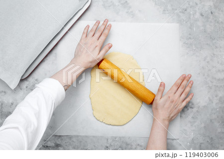 Making different shapes of fall cookies for Halloween. Woman rolling out dough Making different shapes of fall cookies for Halloween. Woman rolling out dough 119403006