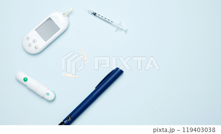 Diabetes concept with glucometer, syringe pen with insulin, blood test strips. Concept of worldwide diabetes awareness. Top view. Copy space Diabetes concept with glucometer, syringe pen with insulin, blood test strips. Concept of worldwide diabetes awareness. Top view. Copy space 119403038