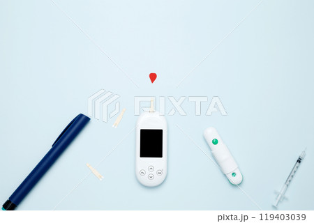 Diabetes concept with glucometer, syringe pen with insulin, blood test strips. Concept of worldwide diabetes awareness. Top view. Copy space 119403039