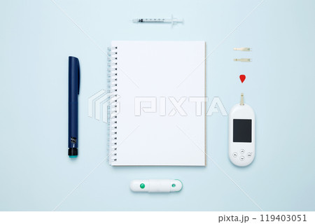 Diabetes concept with glucometer, syringe pen with insulin, blood test strips. Mock up white paper. Concept of worldwide diabetes awareness. 119403051