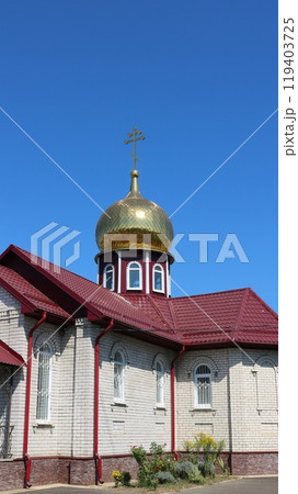 vertical image of orthodox chapel or small church with one golden dome and red roof on sunny day, religious christian architecture small forms, place for prayers in orthodoxy vertical image of orthodox chapel or small church with one golden dome and red roof on sunny day, religious christian architecture small forms, place for prayers in orthodoxy 119403725