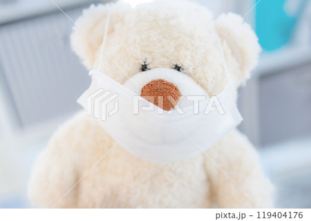 Medical mask on teddy bear 119404176