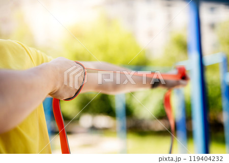 Man exercising with resistance rubber band 119404232