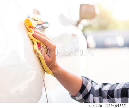 Girl polishing car door Girl polishing car door 119404255