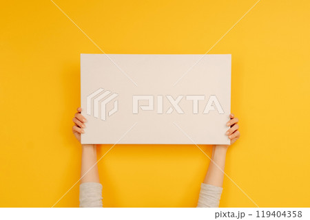Hand holding white canvas 119404358