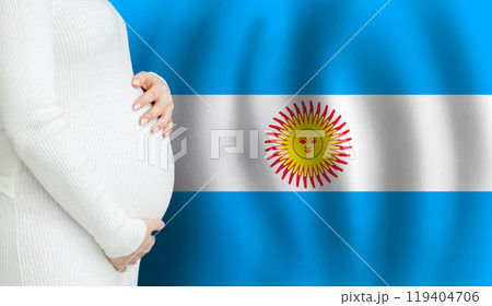 Pregnant woman belly against Argentine flag background. Demographics and pregnancy  119404706