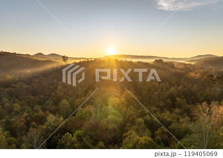 Appalachian mountain hills on autumn evening with brightly illuminated lush and pine woods at fall season. Autumnal landscape of beautiful nature Appalachian mountain hills on autumn evening with brightly illuminated lush and pine woods at fall season. Autumnal landscape of beautiful nature 119405069