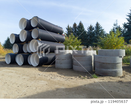 Large drainage pipes and concrete rings at construction site 119405637