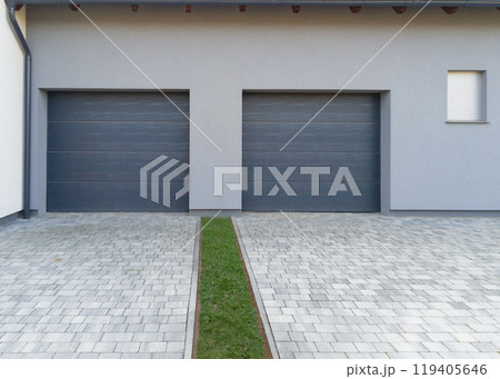 Modern double garage with paved driveway Modern double garage with paved driveway 119405646