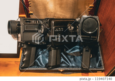 Vintage film cameras displayed in a classic wooden case showcasing unique designs from a bygone era 119407140