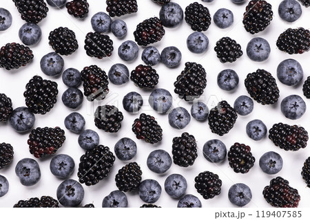 blackberries and blueberries on a white background, close-up, top view. 119407585