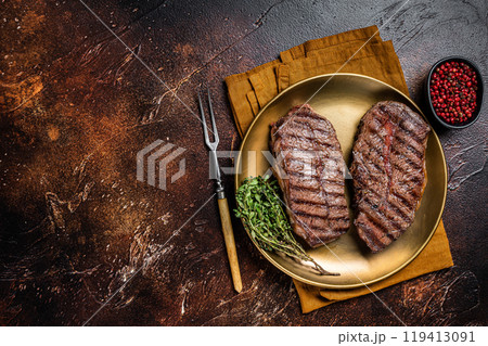 Grilled Shoulder Top Blade or Australia wagyu oyster blade beef steak. Dark background. Top View. Copy space 119413091