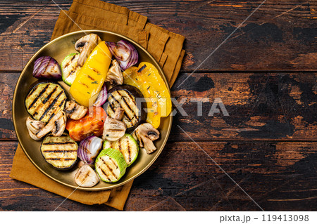 Various grilled Vegetables, bell pepper, zucchini, eggplant, onion and tomato. Wooden background. Top view. Copy space Various grilled Vegetables, bell pepper, zucchini, eggplant, onion and tomato. Wooden background. Top view. Copy space 119413098