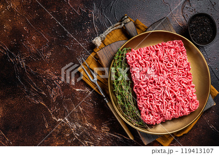 Fresh mutton lamb Mince Meat, raw ground meat. Dark background. Top view. Space for text Fresh mutton lamb Mince Meat, raw ground meat. Dark background. Top view. Space for text 119413107