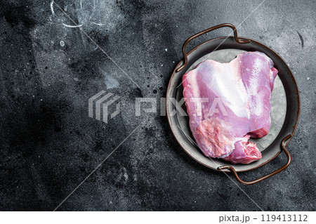 Raw Turkey boneless and skinless thigh fillet. Farm eco meat. Black background. Top view. Space for text 119413112