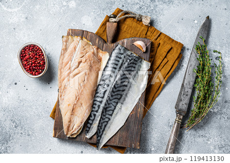Cooking of fresh raw mackerel fillet fish on a cutting board. Gray background. Top view Cooking of fresh raw mackerel fillet fish on a cutting board. Gray background. Top view 119413130
