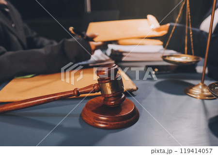 Judge gavel with Justice lawyers having team meeting at law firm background. Concepts of Law and Legal services. Judge gavel with Justice lawyers having team meeting at law firm background. Concepts of Law and Legal services. 119414057
