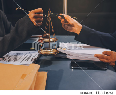 Judge gavel with Justice lawyers having team meeting at law firm background. Concepts of Law and Legal services. 119414068