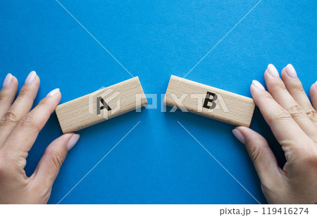 Plan A and Plan B symbol. Concept word Plan A and Plan B on wooden blocks. Businessman hand. Beautiful blue background. Plan A and Plan B concept. Copy space 119416274