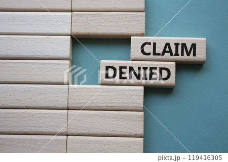 Claim denied symbol. Wooden blocks with words Claim denied. Beautiful grey green background. Business and Claim denied concept. Copy space. 119416305