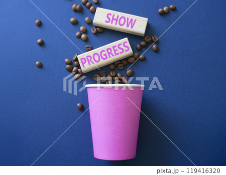 Progress symbol. Wooden blocks with words Show progress. Beautiful deep blue background with coffee cup and coffee beans. Business and Show progress concept. Copy space. 119416320