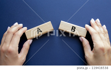 Plan A and Plan B symbol. Concept word Plan A and Plan B on wooden blocks. Businessman hand. Beautiful deep blue background. Plan A and Plan B concept. Copy space 119416538