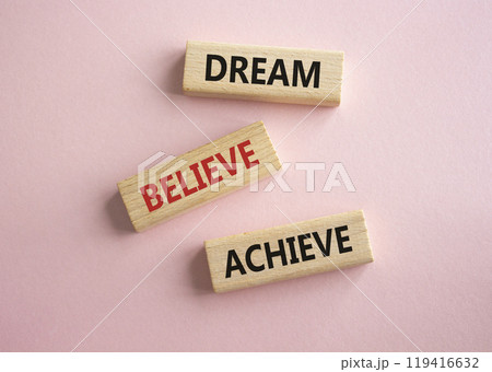 Dream Believe Achieve symbol. Concept words Dream Believe Achieve on wooden blocks. Beautiful pink background. Business and Dream Believe Achieve concept. Copy space 119416632