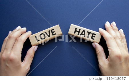 Love vs Hate symbol. Concept word Love vs Hate on wooden blocks. Businessman hand. Beautiful deep blue background. Business and Love vs Hate concept. Copy space Love vs Hate symbol. Concept word Love vs Hate on wooden blocks. Businessman hand. Beautiful deep blue background. Business and Love vs Hate concept. Copy space 119418057