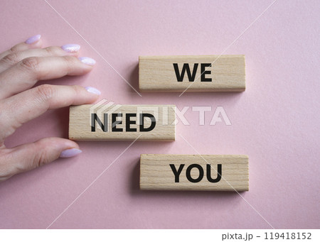 We need you symbol. Concept words We need you on wooden blocks. Beautiful pink background. Businessman hand. Business and We need you concept. Copy space. 119418152