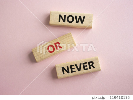 Now or Never symbol. Concept words Now or Never on wooden blocks. Beautiful pink background. Business and Now or Never concept. Copy space 119418156