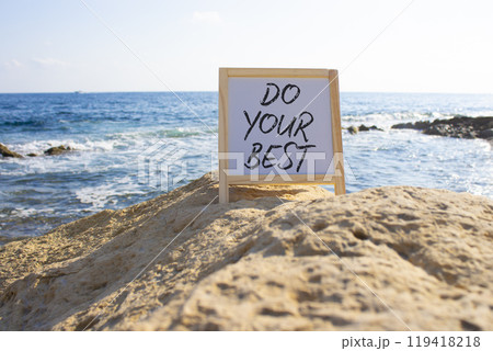 Do your Best symbol. White Blackboard with words Do your Best. Beautiful sea background. Business and Do your Best concept. Copy space. 119418218