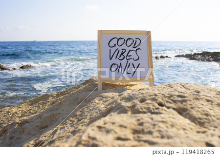 Good Vibes only symbol. White Blackboard with Concept words Good Vibes only. Beautiful sea background. Business and Good Vibes only concept. Copy space. Good Vibes only symbol. White Blackboard with Concept words Good Vibes only. Beautiful sea background. Business and Good Vibes only concept. Copy space. 119418265