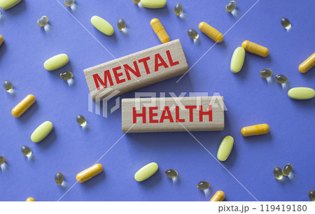 Mental Health symbol. Concept word Mental Health on wooden blocks. Beautiful purple background with pills. Medicine and Mental Health concept. Copy space Mental Health symbol. Concept word Mental Health on wooden blocks. Beautiful purple background with pills. Medicine and Mental Health concept. Copy space 119419180