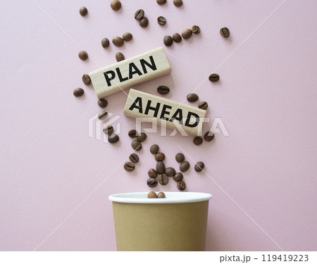 Plan ahead symbol. Wooden blocks with words Plan ahead. Beautiful pink background with coffee cup and coffee beans. Business and Plan ahead concept. Copy space. 119419223