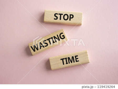 Stop Wasting Time symbol. Wooden blocks with words Stop Wasting Time. Beautiful pink background. Business and Stop Wasting Time concept. Copy space. 119419264