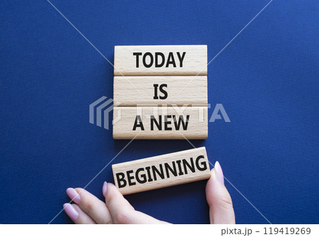 Today is a new beginning symbol. Wooden blocks with words Today is a new beginning. Beautiful deep blue background. Businessman hand. Business and Today is a new beginning concept. Copy space. 119419269