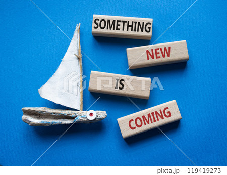 Smth New is coming symbol. Wooden blocks with words Something New is coming. Beautiful blue background with boat. Business and Something New is coming concept. Copy space. 119419273