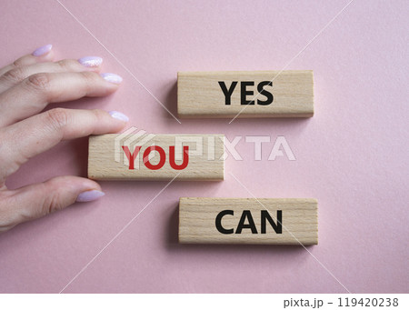 Yes You Can symbol. Concept word Yes You Can on wooden blocks. Beautiful pink background. Businessman hand. Business and Yes You Can concept. Copy space. Yes You Can symbol. Concept word Yes You Can on wooden blocks. Beautiful pink background. Businessman hand. Business and Yes You Can concept. Copy space. 119420238