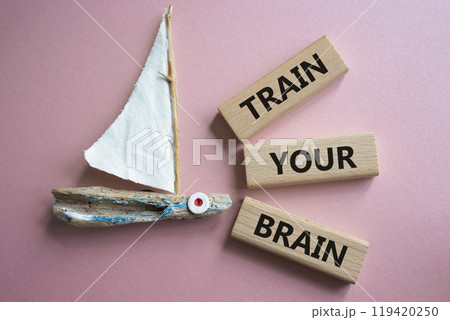 Train Your Brain symbol. Concept words Train Your Brain on wooden blocks. Beautiful pink background with boat. Healthcare and Train Your Brain concept. Copy space. Train Your Brain symbol. Concept words Train Your Brain on wooden blocks. Beautiful pink background with boat. Healthcare and Train Your Brain concept. Copy space. 119420250