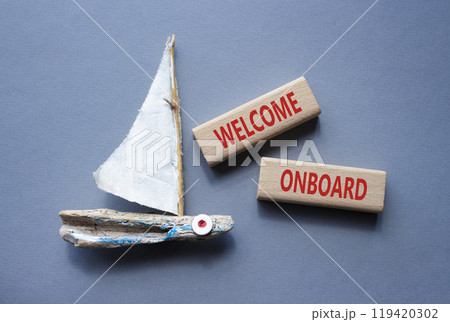 Welcome onboard symbol. Concept words Welcome onboard on wooden blocks. Beautiful grey background with boat. Business and Welcome onboard concept. Copy space. Welcome onboard symbol. Concept words Welcome onboard on wooden blocks. Beautiful grey background with boat. Business and Welcome onboard concept. Copy space. 119420302