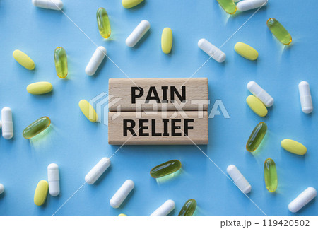 Pain Relief symbol. Concept word Pain Relief on wooden blocks. Beautiful blue background with pills. Medicine and Pain Relief concept. Copy space Pain Relief symbol. Concept word Pain Relief on wooden blocks. Beautiful blue background with pills. Medicine and Pain Relief concept. Copy space 119420502
