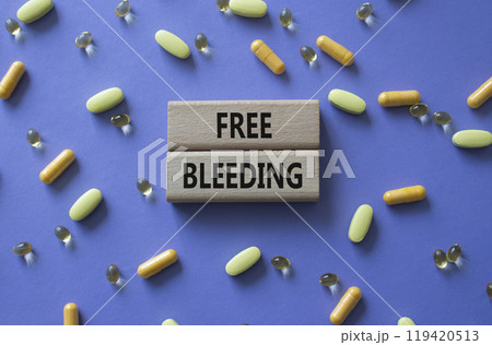 Free bleeding symbol. Concept words Free bleeding on wooden blocks. Beautiful purple background with pills. Motivational and Free bleeding concept. Copy space. Free bleeding symbol. Concept words Free bleeding on wooden blocks. Beautiful purple background with pills. Motivational and Free bleeding concept. Copy space. 119420513