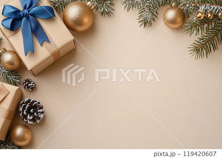 Commemorate New Year in elegance. Top view perspective of carefully wrapped giftbox, chic tree ornaments, glittery balls, seasonal adornments on beige backdrop Commemorate New Year in elegance. Top view perspective of carefully wrapped giftbox, chic tree ornaments, glittery balls, seasonal adornments on beige backdrop 119420607