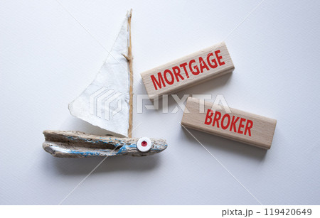 Mortgage Broker symbol. Concept word Mortgage Broker on wooden blocks. Beautiful white background with boat. Business and Mortgage Broker concept. Copy space 119420649