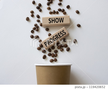 Progress symbol. Wooden blocks with words Show progress. Beautiful white background with coffee cup and coffee beans. Business and Show progress concept. Copy space. 119420652