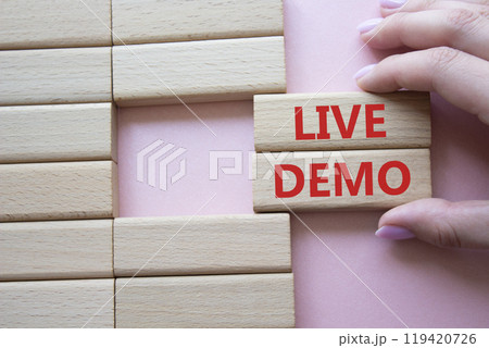 Live Demo symbol. Concept word Live Demo on wooden blocks. Beautiful pink background. Businessman hand. Business and Live Demo concept. Copy space Live Demo symbol. Concept word Live Demo on wooden blocks. Beautiful pink background. Businessman hand. Business and Live Demo concept. Copy space 119420726