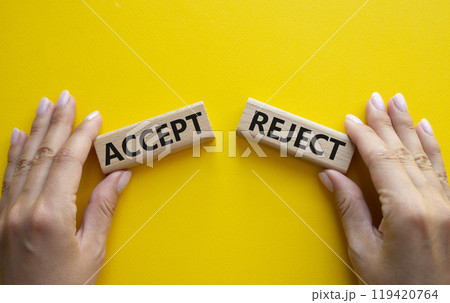 Accept or Reject symbol. Concept word Accept or Reject on wooden blocks. Businessman hand. Beautiful yellow background. Business and Accept or Reject concept. Copy space Accept or Reject symbol. Concept word Accept or Reject on wooden blocks. Businessman hand. Beautiful yellow background. Business and Accept or Reject concept. Copy space 119420764