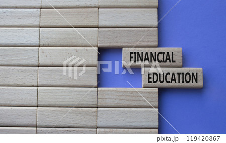 Financial Education symbol. Concept word Financial Education on wooden blocks. Beautiful purple background. Business and Financial Education concept. Copy space 119420867